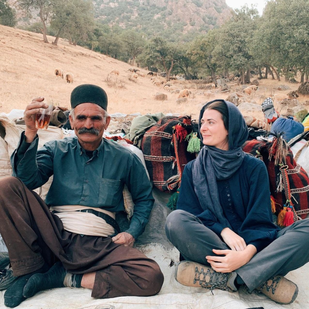 Tourist having tea with nomads